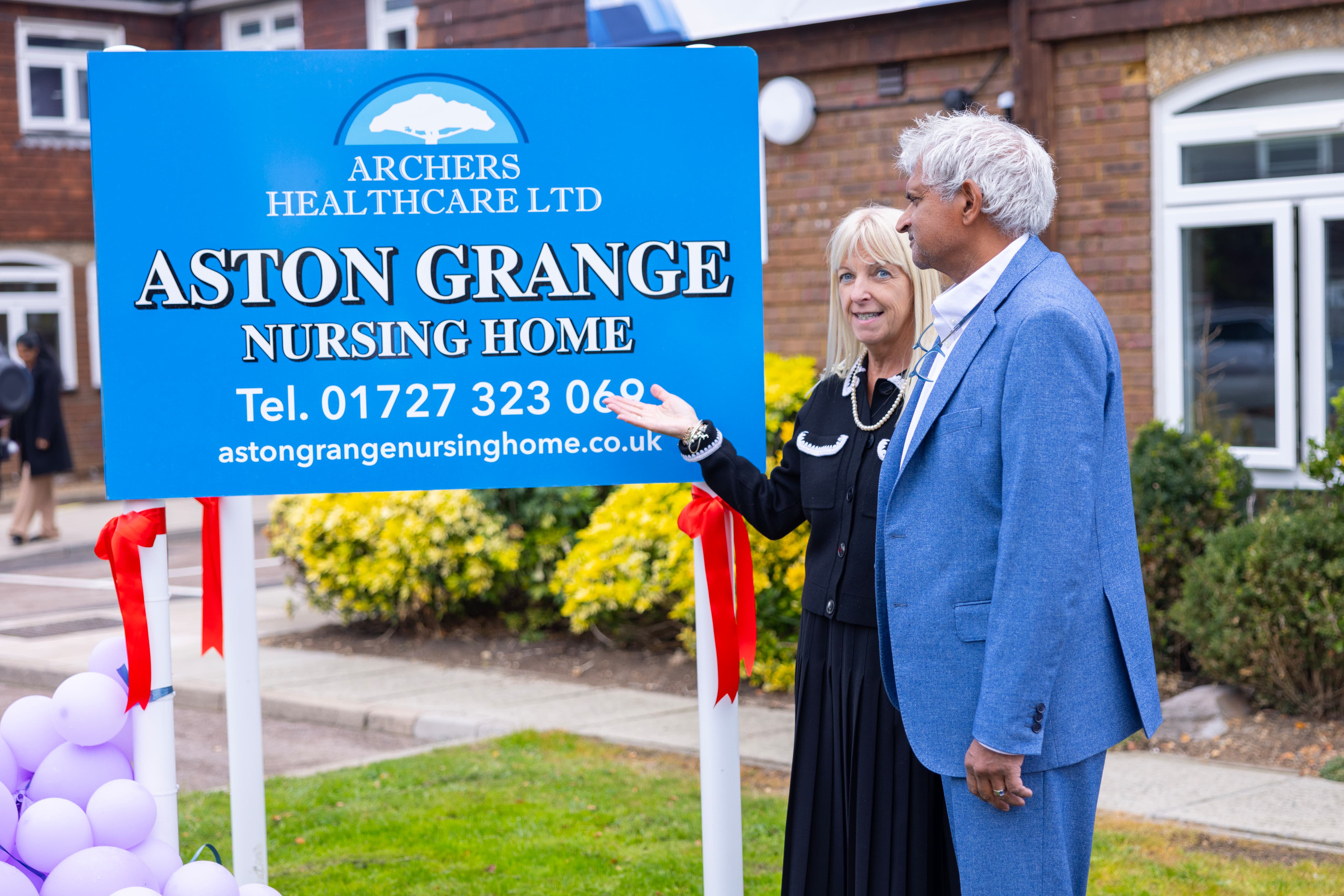 Directors Mr Ravi Selliah and Mrs Julie Archer-Moran with the Aston Grange sign